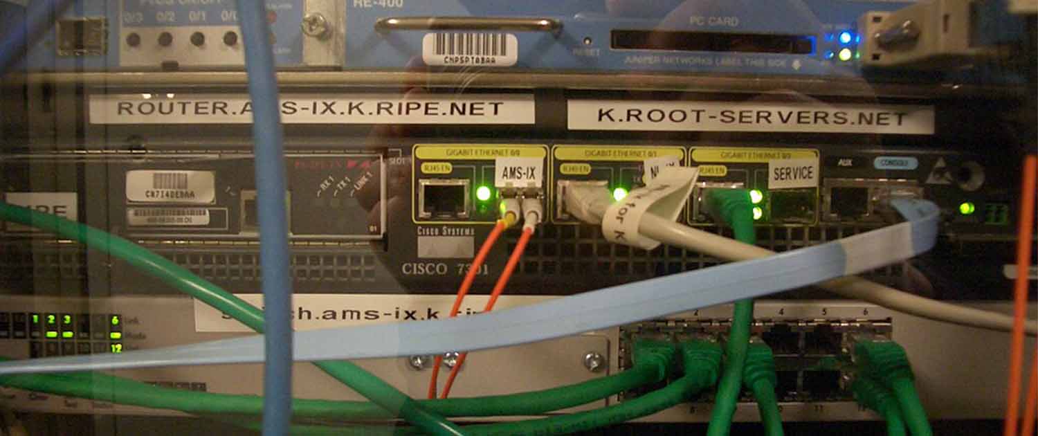 Photo of a Cisco 7301 router and a Juniper M7i, part of the K root-server instance at AMS-IX