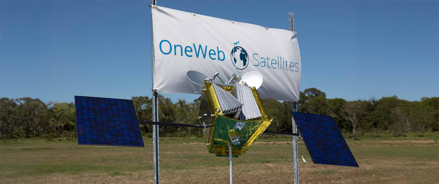 Photo of a OneWeb satellite in front of a OneWeb banner