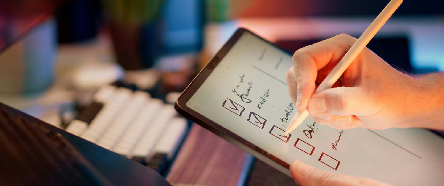 Photo of a person with a tablet checking off a list of things